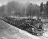 Steam locomotive with passenger train at speed on curve