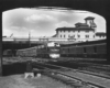 Diesel powered passenger train departing elevated station