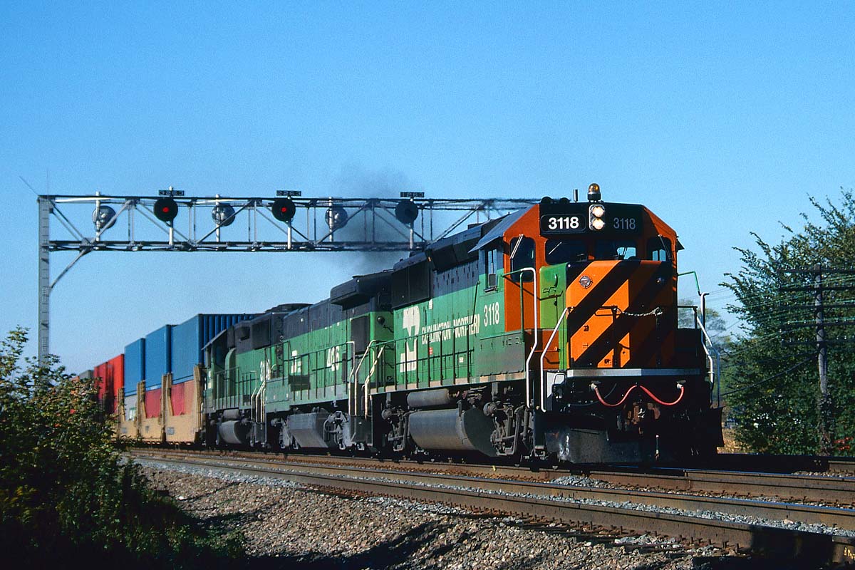 In October 1985, a nearly-new Burlington Northern tiger-stripe GP50 leads a B30-7A(B) and a Frisco-ordered GP50 on a stack train on the Racetrack east of Naperville, Ill.