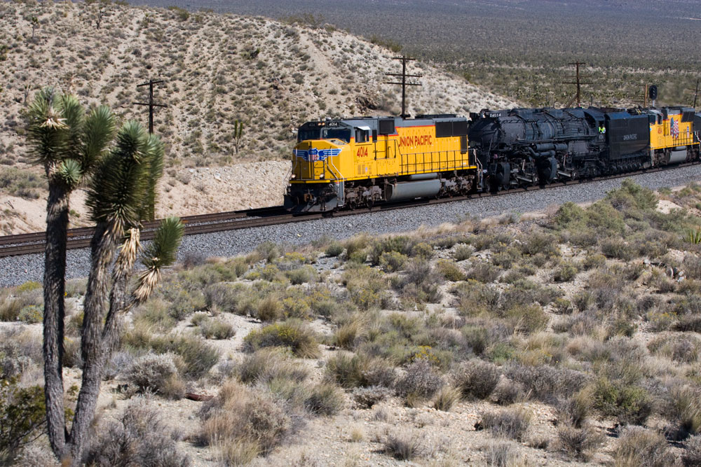 Big boy passing by with hills next to it