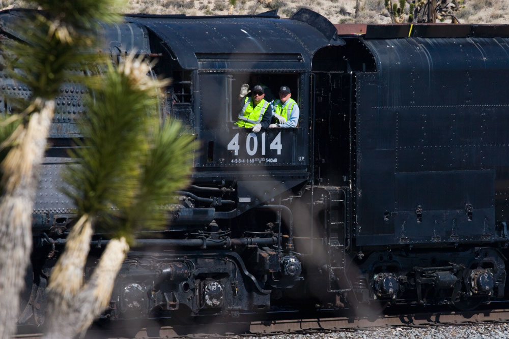 Big boy conductors waving out the train window