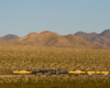 A distant shot of big boy speeding by with the mountains in the background