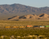 A distant shot of big boy passing through the mountains