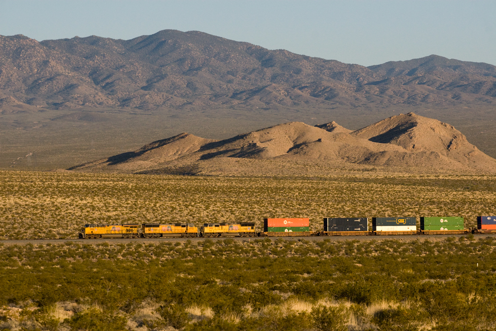 A distant shot of big boy passing through the mountains