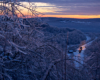A distant, overhead, shot of a train passing through a snowy area