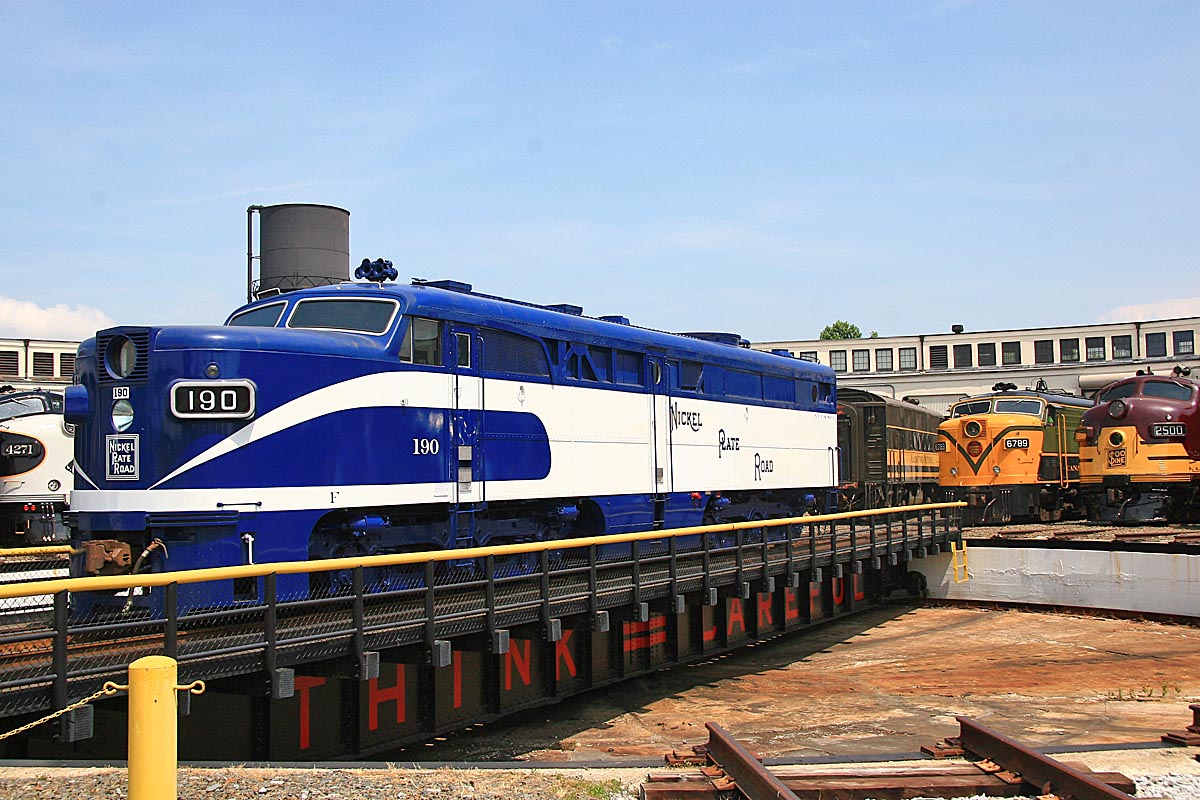 A blue and white train in a turntable