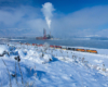A distant shot of a train traveling through a snowy area