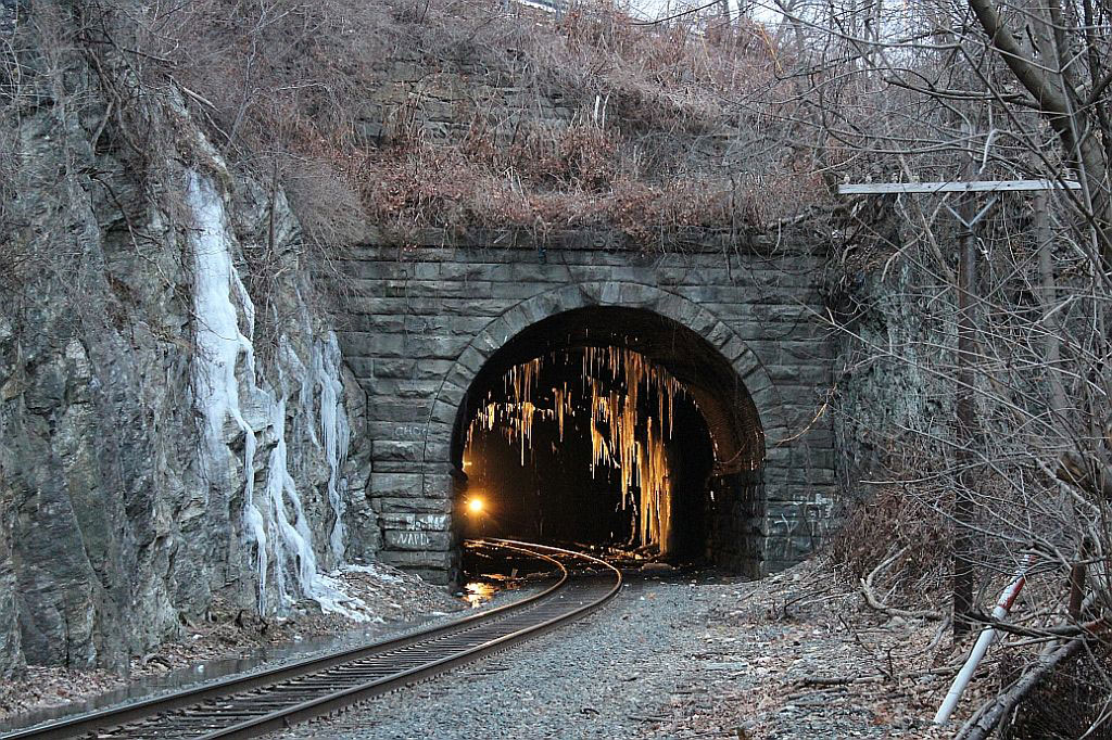 A train tunnel with icicles hanging off it