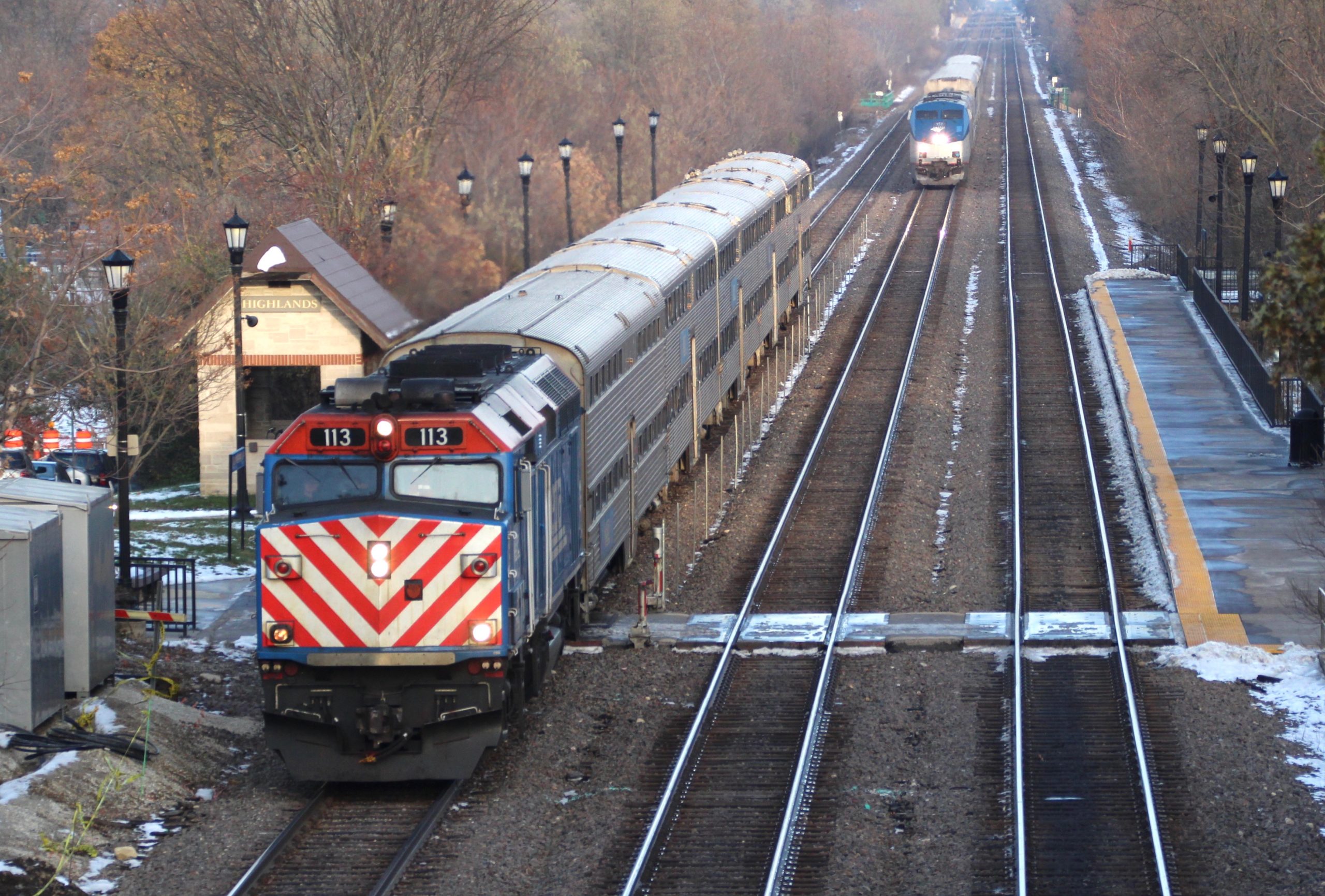 A Metra BNSF train stops at Highlands station in Hinsdale, Ill., on Nov. 15, 2019 as Amtrak's Southwest Chief approaches. Highlands is among the 31 stations to be upgraded by Metra in the next five years.