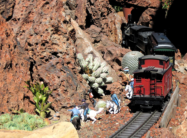 model train next to rocks and cacti; Model a miniature desert