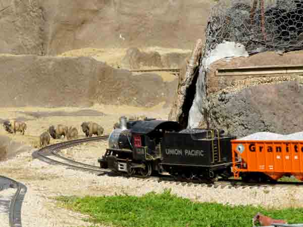 black model engine on curve of track on garden railway
