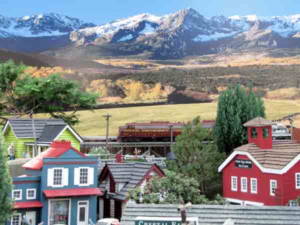 city scene on garden railway with mountains in background