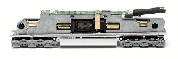 The printed-circuit board mounted on top of the split-frame mechanism has golden-white light-emitting diodes soldered to each end.