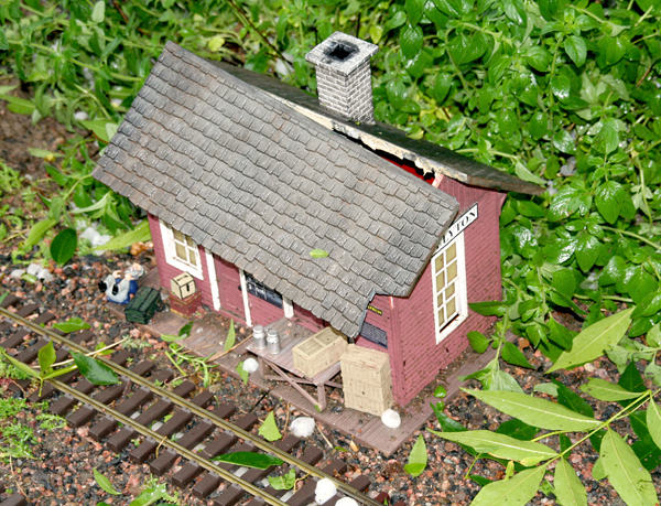 broken plastic structure on garden railway