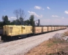 Yellow center-cab diesel with yellow coal cars