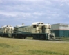 Two yellow and green diesel locomotives