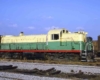 Yellow and green diesel locomotive in yard