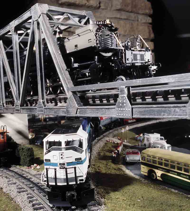 model train running under bridge