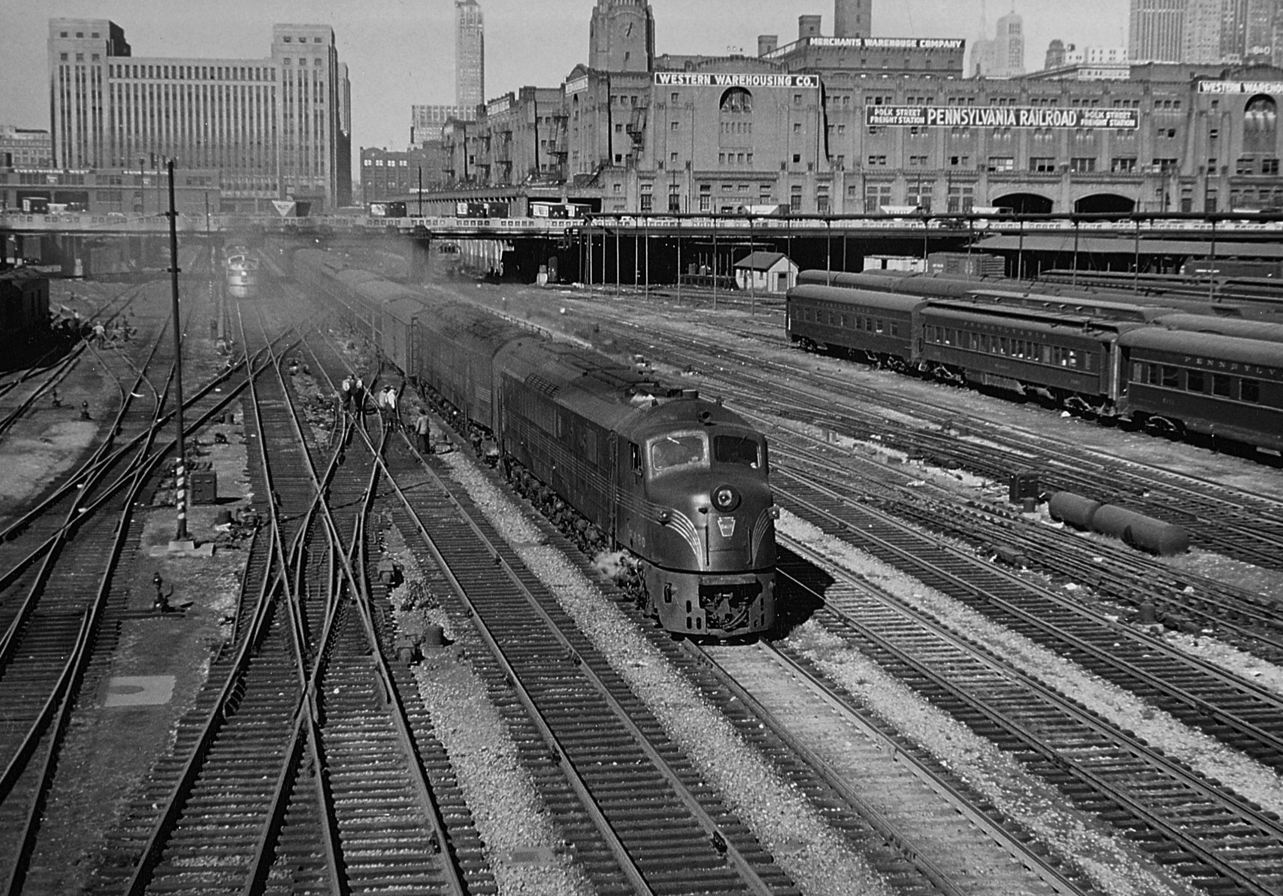 Two Baldwin “Centipede” diesel locomotives depart Chicago Union Station with the Union bound for Cincinnati in October 1950. Part of PRR’s big Chicago coach yard is at right. 