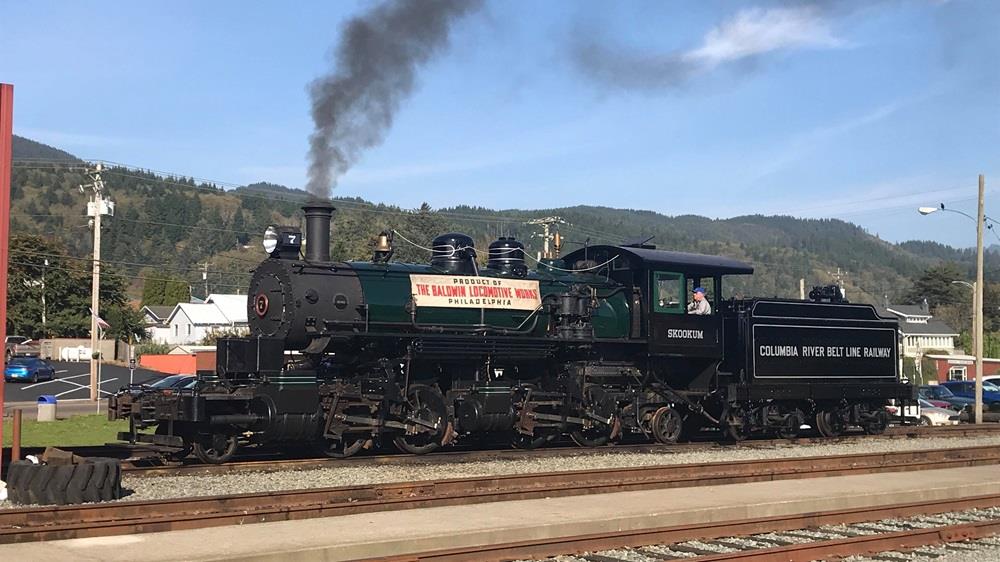 Articulated steam locomotive sitting under steam.