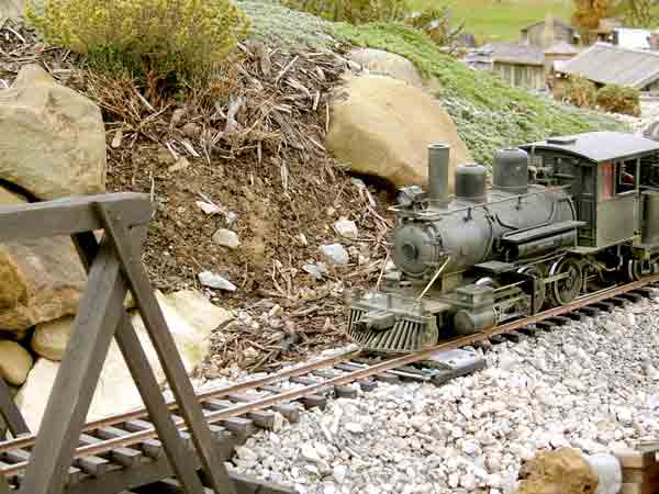 locomotive approaching bridge on garden railway