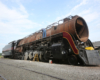 A side angle photo of a man working on a train