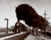 Two guys stand off to the side as a train passes by with big black smoke coming out of its chimney