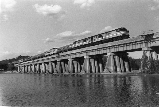 black and white auto train on bridge above water