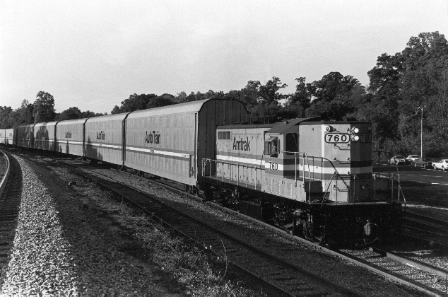 black and white train photo on tracks