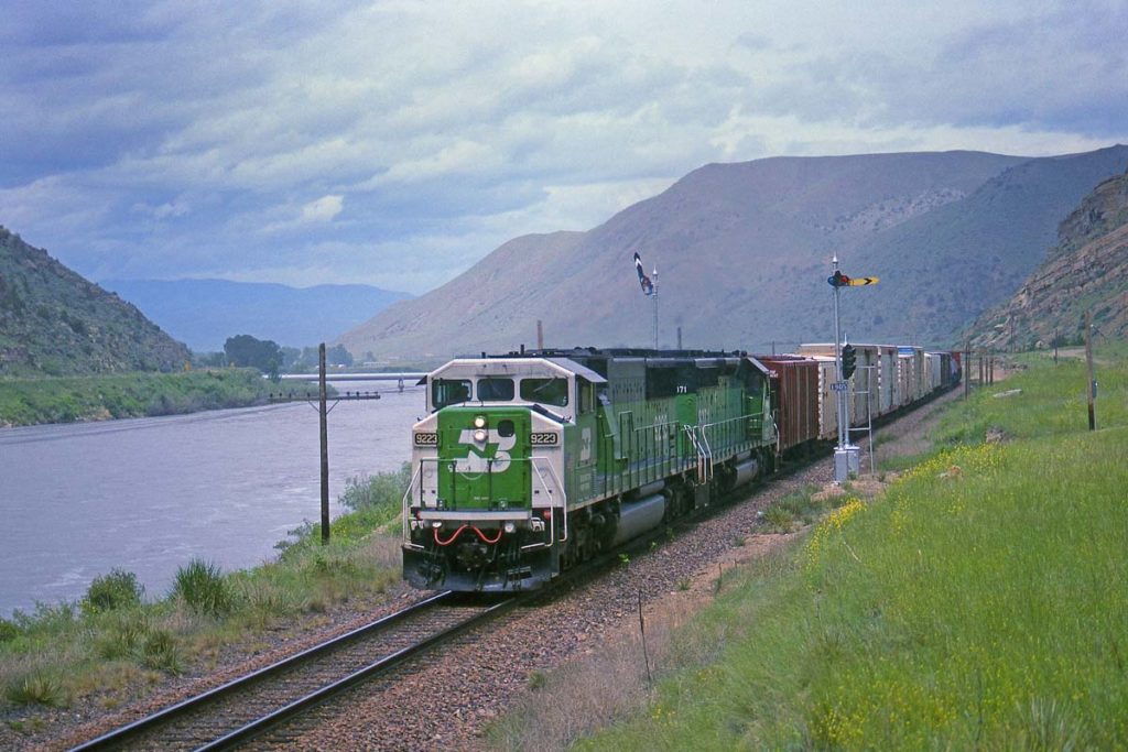 On June 10, 1993, a Burlington Northern SD60M and SD40-2 take an eastbound freight along the Missouri River and into Lombard Canyon just east of Toston, Mont.