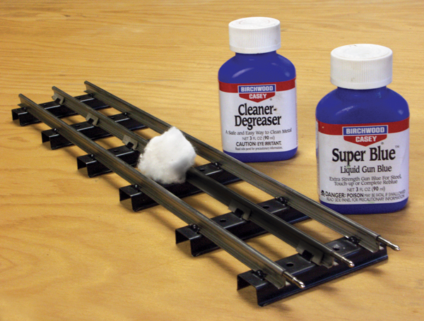 O gauge track with bottles of cleaner