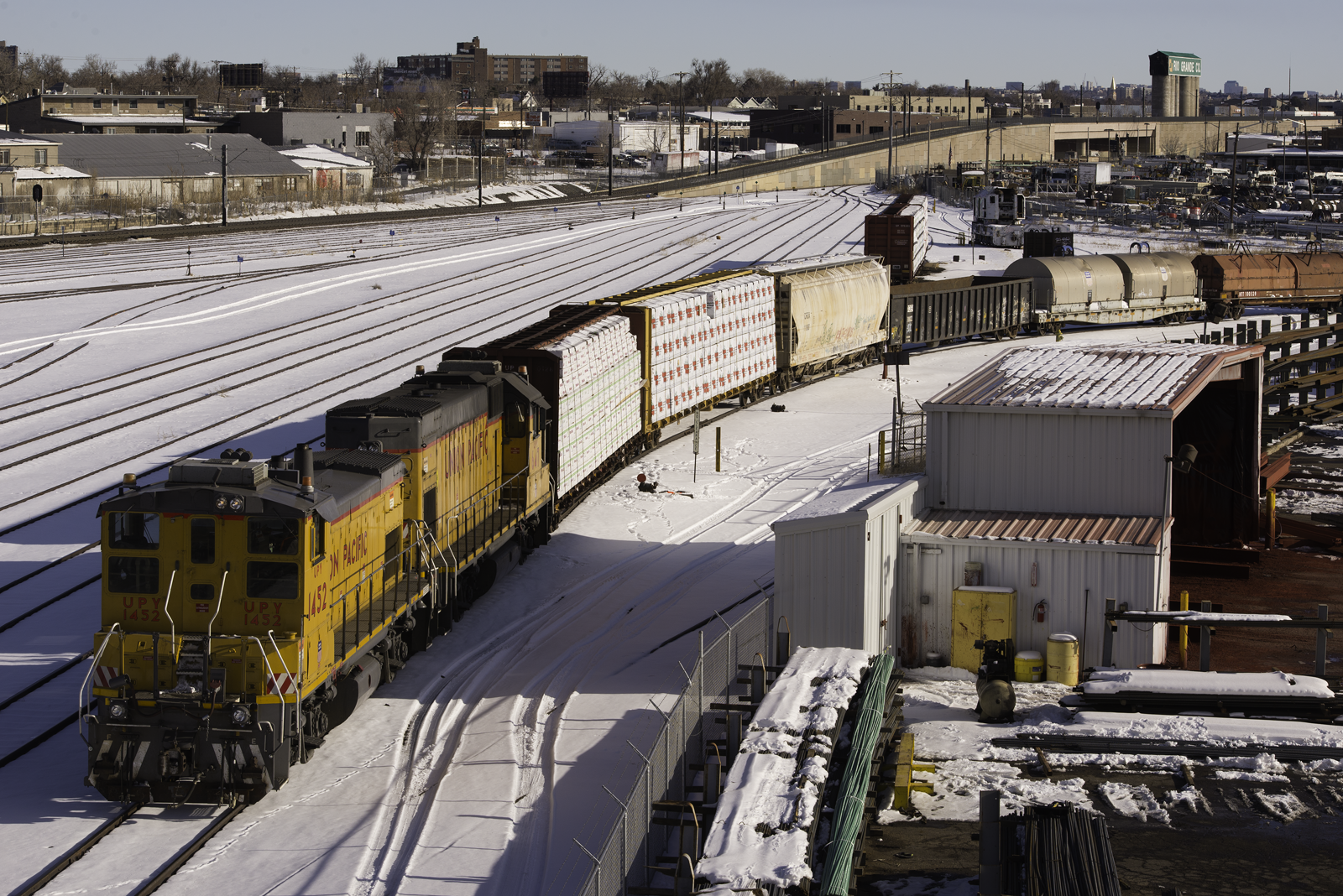 Yellow locomotives working in snow-covered yards