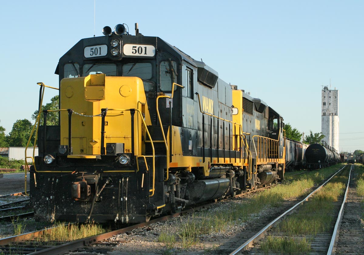 Black and yellow locomotives in yard