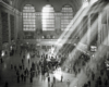 An overhead shot of people walking inside grand central station with light coming through the window