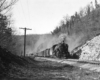 A black and white photo of  K-4 2-8-2 Mikado heading down the tracks