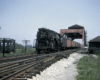 A train passing beneath a tower