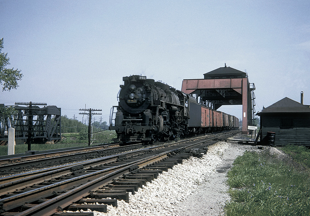 A train passing beneath a tower