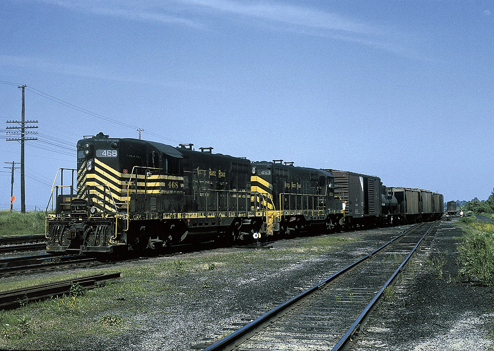 A black and yellow striped train passing by