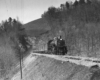 A black and white photo of Clinchfield coming out of a tunnel on a raised track