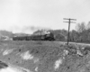 A black and white photo of the Clinchfield Railroad 4-6-2 coming down the tracks on a raised track