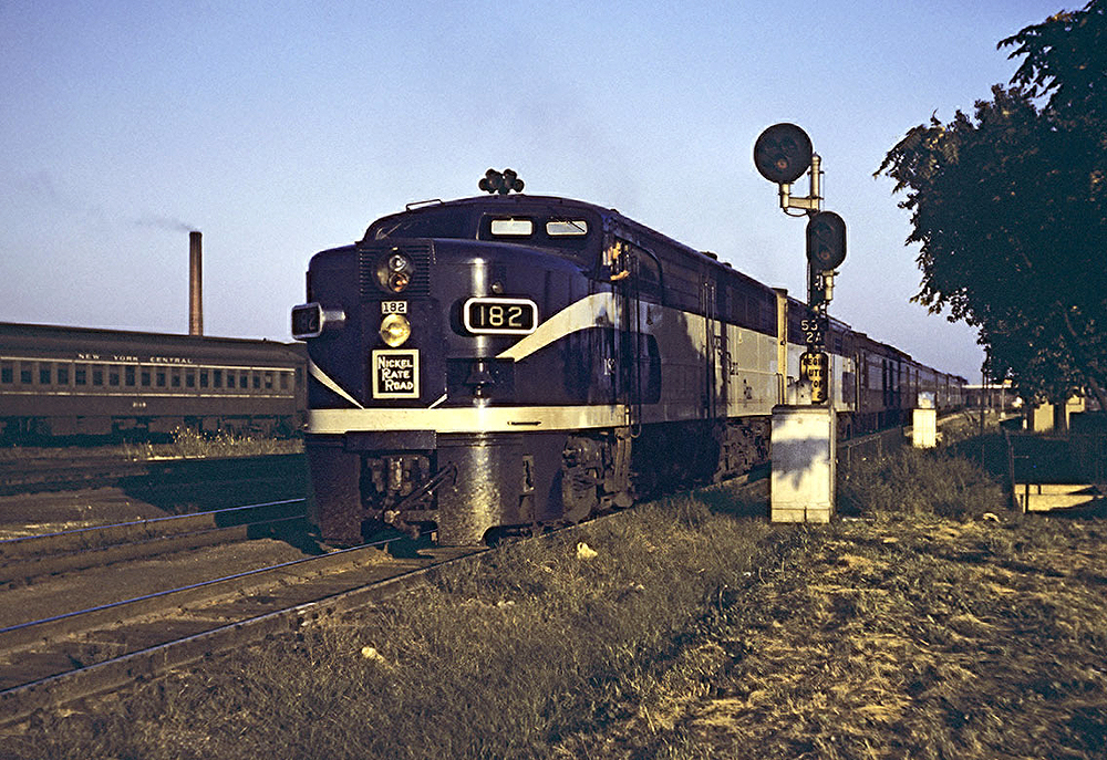 “Bluebird” PA 182, with Nickel Plate’s unique notched-nose bell, and a sister are ready to leave Englewood with train 7, the Westerner, in 1959. 