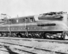 A black and white photo of a GG1 electric locomotive sitting on the tracks