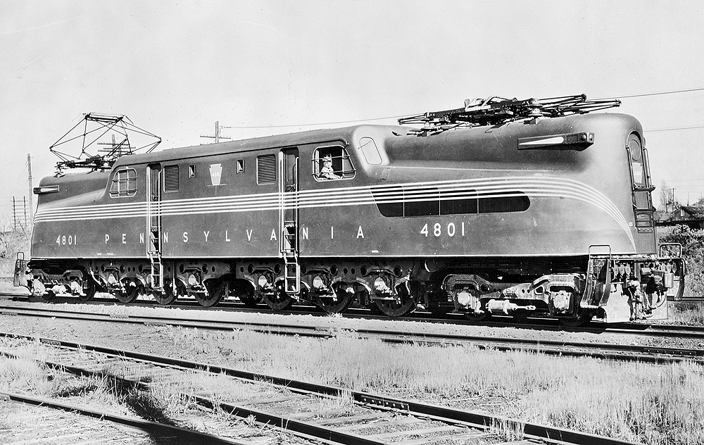 A black and white photo of a GG1 electric locomotive sitting on the tracks