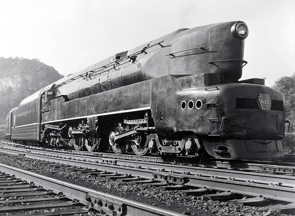 A close up black and white photo of a T1 4-4-4-4 high-speed passenger duplex sitting on the tracks