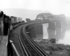 Looking back at a train passing over a bridge