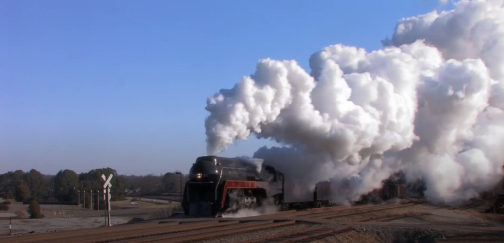 Steam locomotive with smoke clouds