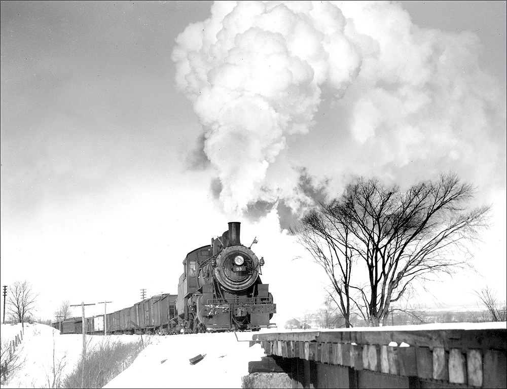 Steam locomotive with freight train in snow