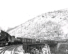 Steam locomotive with freight train on curved trestle