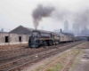 a streamliner pulling passenger cars with chicago in the background