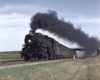 a steam engine pulling passenger cars